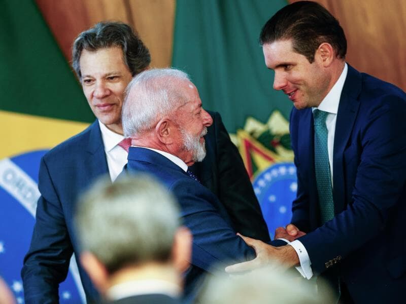 Hugo Motta cumprimenta o presidente Lula diante do ministro Fernando Haddad no dia 13 de agosto, no lançamento do plano Brasil Soberano. - Gabriela Biló/Folhapress